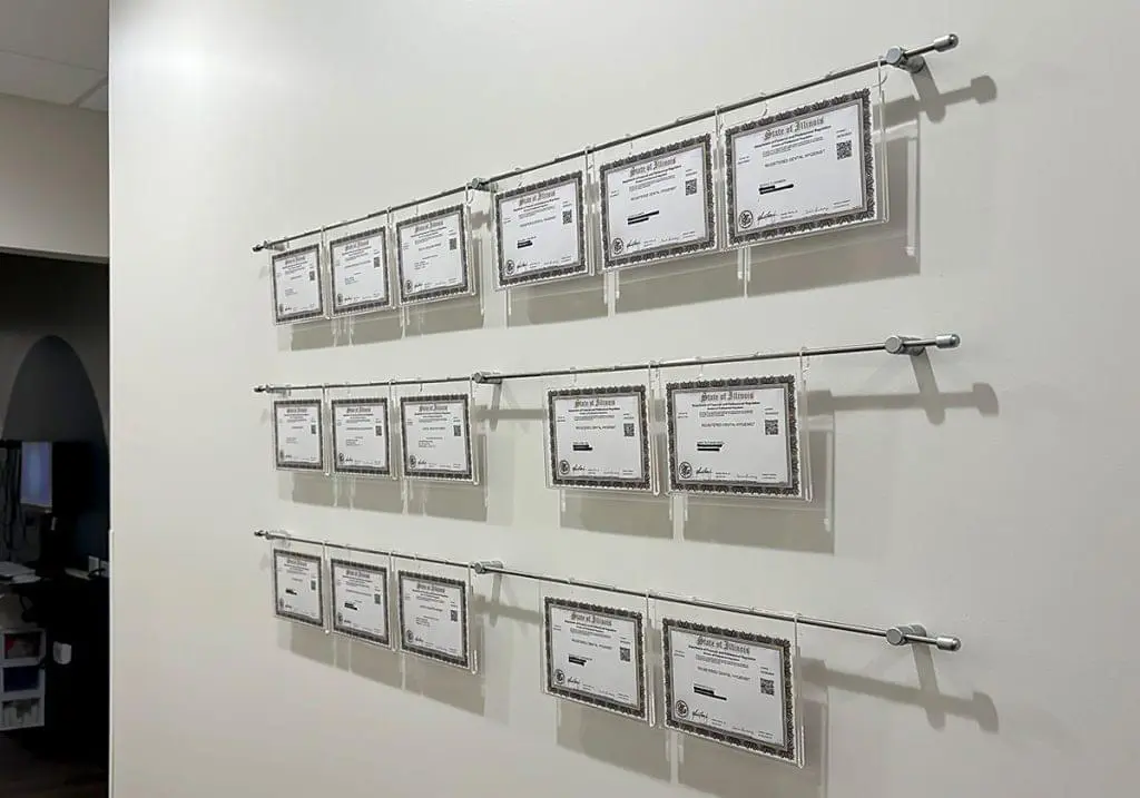 R2021 — Certificate Wall Displays with Hook-On Acrylic Frames Mounted to Wall with Horizontal Rod System