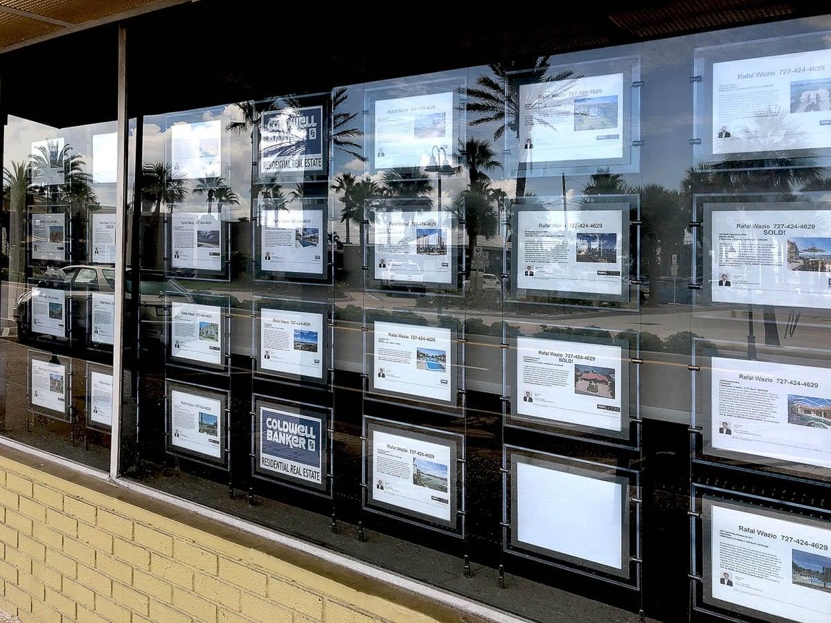 L1016 — LED Backlit Displays for Real Estate Listings / Cable Suspended in Window