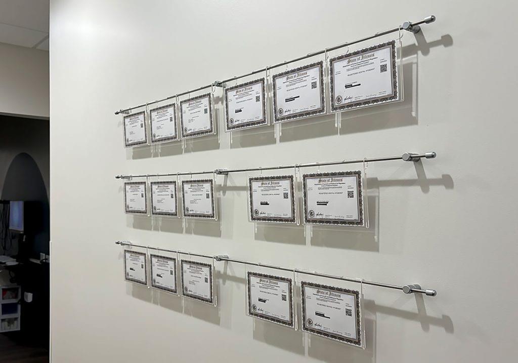 R2021 — Certificate Wall Displays with Hook-On Acrylic Frames Mounted to Wall with Horizontal Rod System