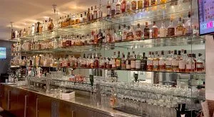 Glass Bar Shelves Suspended with Rod Hanging Systems | Nova Display Systems