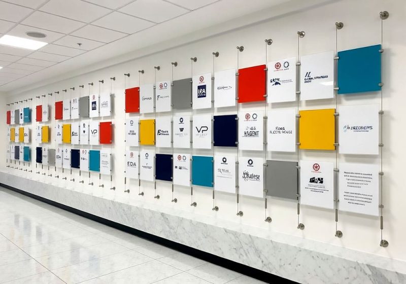 C1043 — Information Wall Display with Cable Systems and Easy-Access Acrylic Pockets
