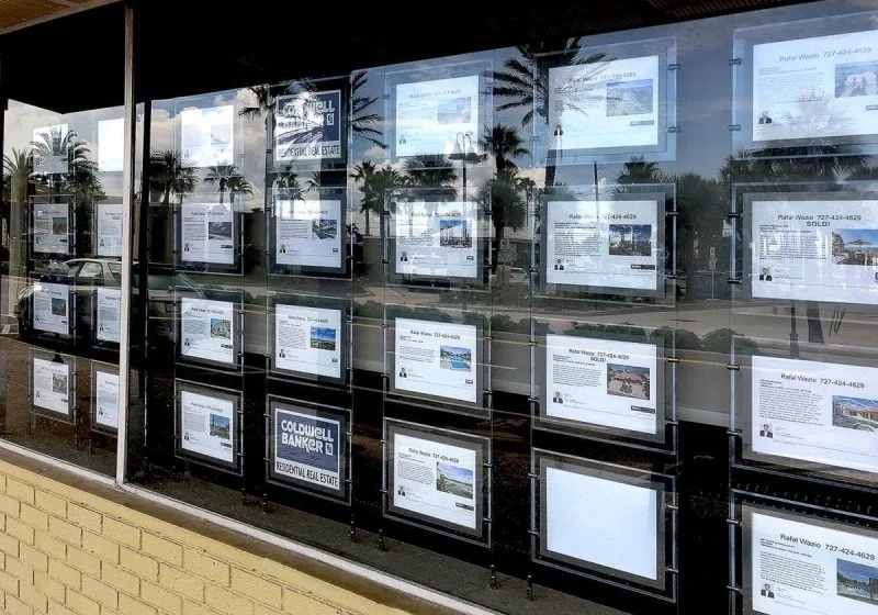 L1016 — LED Backlit Displays for Real Estate Listings / Cable Suspended in Window